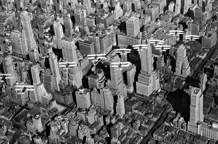 United States Army Air Corp biplanes flying in formation over Midtown Manhattan and the recently completed Chrysler Building. Circa early 1930s.