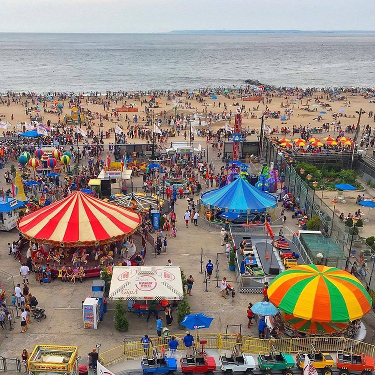 Summer fun in Luna Park, and a view of the beach and boardwalk in Coney Island, New York City
