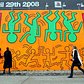 People walk by a re-creation of an untitled mural painted by artist Keith Haring on the corner of Houston Street and Bowery in Manhattan May 2, 2008 in New York City.