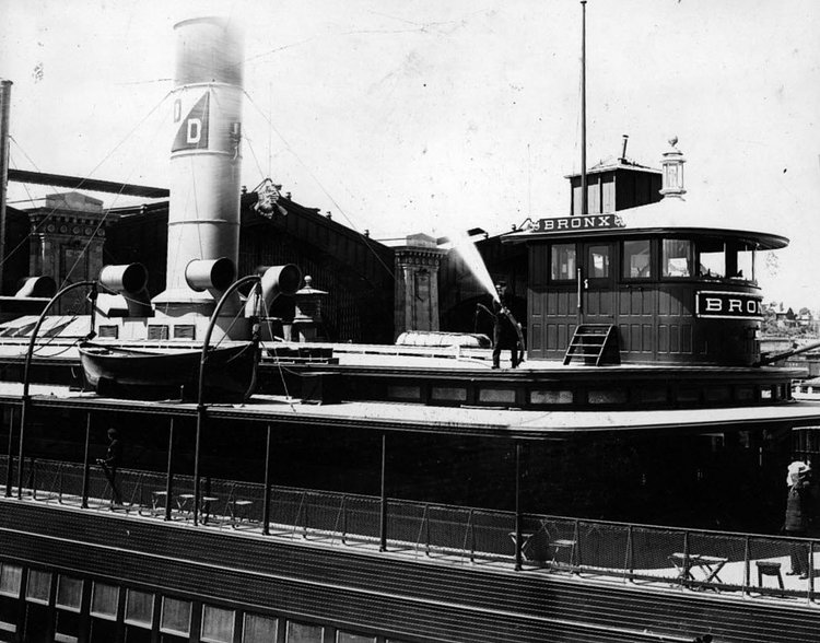 A fire hose is being tested at the Staten Island Ferry Terminal. In 1946 a fire destroyed the structure, burning throughout the night. Photo taken on October 1980. 