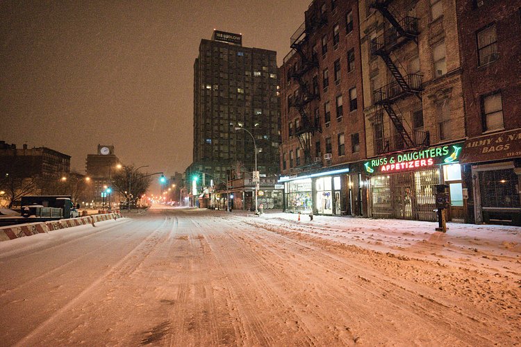 New York City - Snow - Winter Storm Juno - Empty Houston Street | Juno: The first snowstorm of 2015 in New York City.

---

(Note: My <a href="http://www.amazon.com/gp/product/1440339589/ref=as_li_tl?ie=UTF8&amp;camp=1789&amp;creative=9325&amp;creativeASIN=1440339589&amp;linkCode=as2&amp;tag=nyththle0e-20&amp;linkId=ER6GYT5FRYNMEPLF" rel="nofollow">New York photography book</a> released worldwide in stores/online recently and has photos similar to this  [full info below])

---

I have been photographing New York City during snowstorms at night for the past 5 years. When it comes to experiencing <a href="http://nythroughthelens.com/tagged/snow" rel="nofollow">New York City in the snow</a>, I relish the challenge. The more gusty, snowy, and brutal the storm, the more of a chance that I will be out in it traipsing around New York City with my cameras in tow.

When I heard that the MTA was suspending all transit service (and most vehicles) at 11 pm, I made the decision to take the train up to the Upper East Side prior to 11 pm to deposit myself up there with the intention of walking from the Upper East Side to Times Square and then walking the several miles back to the Lower East Side (whew!!).

The streets were eerily empty.

Emptier than they are usually at night during snowfall. Since there was a ban on all vehicles aside from snow plows and emergency services, there were practically no cars at all on the streets. Even taxis were banned from the streets!

I walked in the middle of avenues and streets that are usually teeming with cars.

There was an eerie sense of calm.

It was magical.


---

This is part of a post that I posted to my NYC photography blog. If you are curious enough to look at the photos there, here is the link to the post:

<a href="http://nythroughthelens.com/post/109291619025/new-york-city-snow-winter-storm-juno-i" rel="nofollow">New York City - Winter Storm Juno</a>


----

* As mentioned above - My New York City coffee table book that released in stores/online worldwide recently.

 Tons of information about my <a href="http://www.amazon.com/gp/product/1440339589/ref=as_li_tl?ie=UTF8&amp;camp=1789&amp;creative=9325&amp;creativeASIN=1440339589&amp;linkCode=as2&amp;tag=nyththle0e-20&amp;linkId=ER6GYT5FRYNMEPLF" rel="nofollow">New York photography book</a> with sample pages (including where to order and what stores are carrying it) here:

<a href="http://nythroughthelens.com/post/92873566010/ny-through-the-lens-the-book-i-am-super" rel="nofollow">NY Through The Lens: A New York Coffee Table Book</a>
---


View my New York City photography at my website <a href="http://nythroughthelens.com/" rel="nofollow">NY Through The Lens</a>.

View my Travel photography at my travel blog: <a href="http://travelinglens.me/" rel="nofollow">Traveling Lens</a>.

Interested in my work and have questions about PR and media? Check out my:

<a href="http://nythroughthelens.com/about" rel="nofollow">About Page</a> | <a href="http://nythroughthelens.com/PR" rel="nofollow">PR Page</a> | <a href="http://nythroughthelens.com/media" rel="nofollow">Media Page</a>