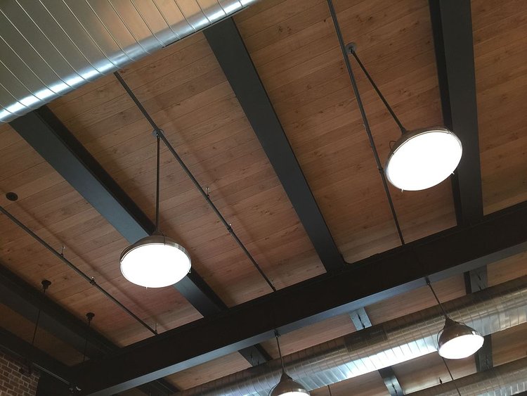 Industrial lights and wooden ceilings keep the vintage warehouse look and feel.