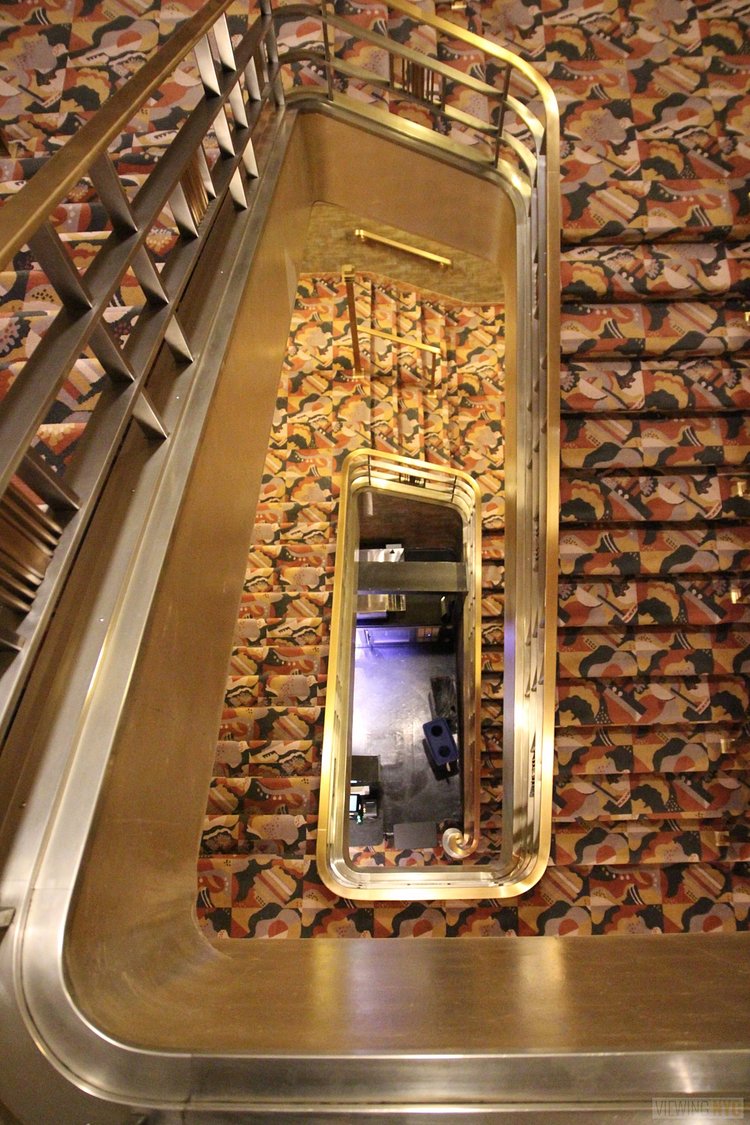 Main Spiral Staircase | Built in 1932, Radio City Music Hall is a prime example of art deco architectural style that has withstood the test of time. With tons of gold, reflective surfaces and geometric design, walking through the venue is a bit like stepping back in time. Most of the fixtures, furniture and ornamentation are original, and any replacements are exact replicas of how the theater looked 80 years ago.

Read more here: <a href="https://viewing.nyc/i-braved-a-walkthrough-of-radio-city-music-hall-meant-for-tourists/" rel="nofollow">viewing.nyc/i-braved-a-walkthrough-of-radio-city-music-ha...</a>