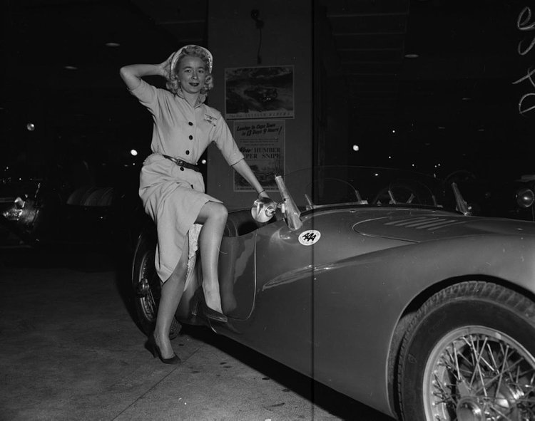 This model looks ready to jump into this low-slung sports car at the Motor Sports Show.