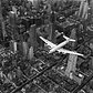 Life magazine photographer Margaret Bourke-White snapped this photo showing a DC-4 passenger plane flying over midtown Manhattan in 1939.