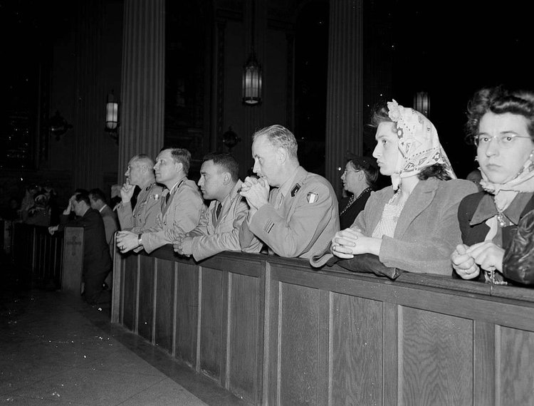 Worshippers pray at noon mass at St. Vincent de Paul’s church on 23rd Street