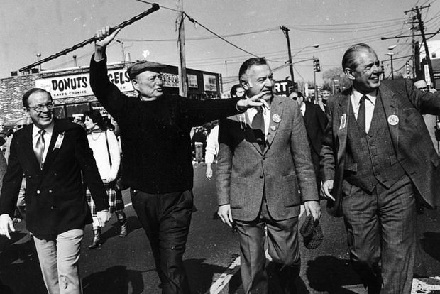 At the 1985 Staten Island St. Patrick's Day Parade, shillelagh-waving Mayor Ed Koch marches with Borough President Ralph Lamberti (far left), late Deputy Borough President Nick LaPorte (second from right) and state Senator John J. Marchi (far right).