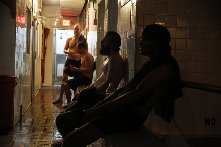 Visitors relax in the common area between saunas, steam rooms and an ice-cold pool in the East Village bathhouse.