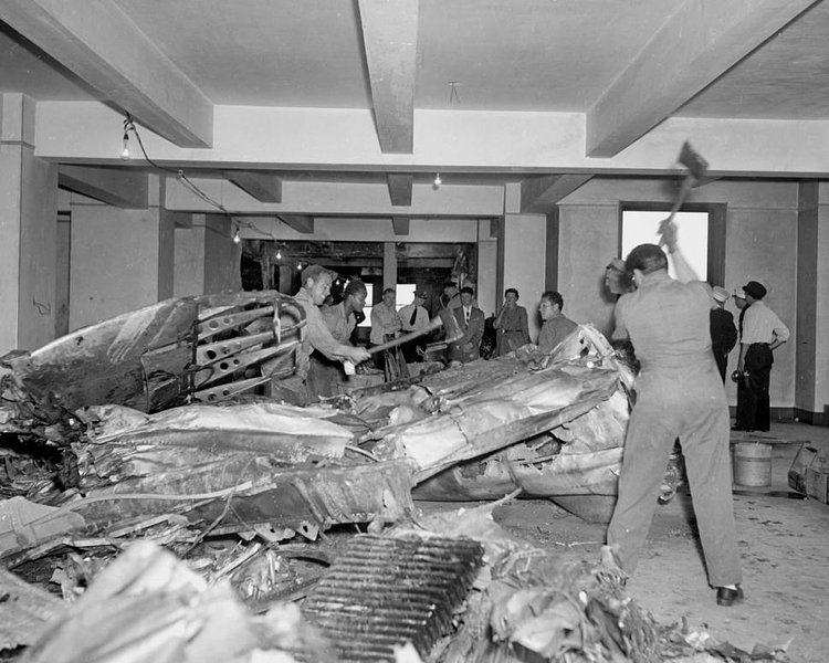 Pieces which crashed the building are cut up for removal from the 78th floor.