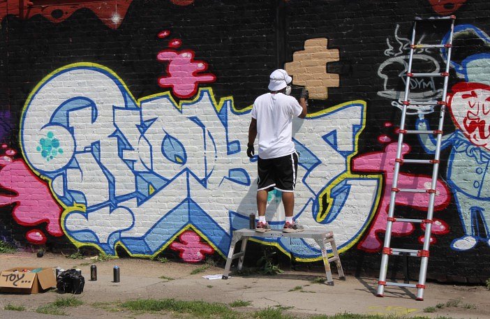 Graffiti artist working on a commissioned piece.
