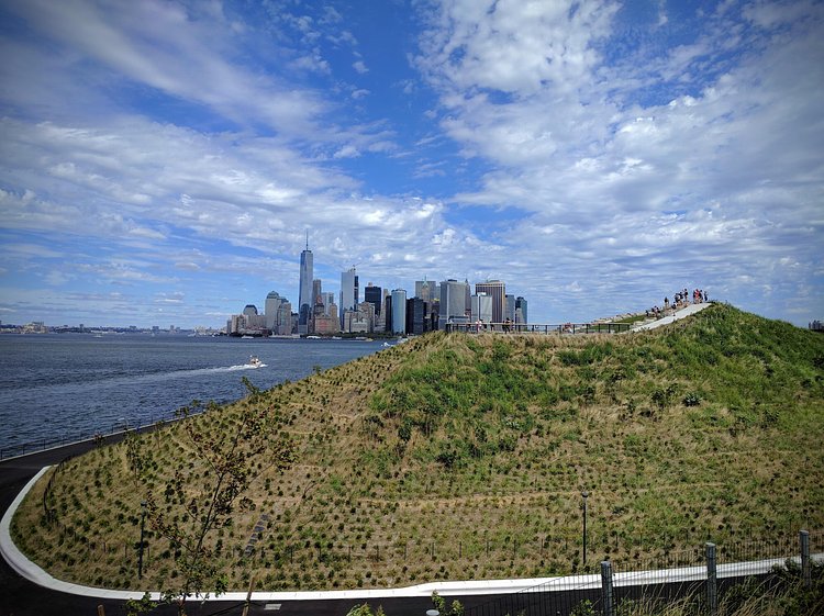 A majestic view of Downtown Manhattan and One World Trade from The Hills on Governors island on Sept 11, 2016