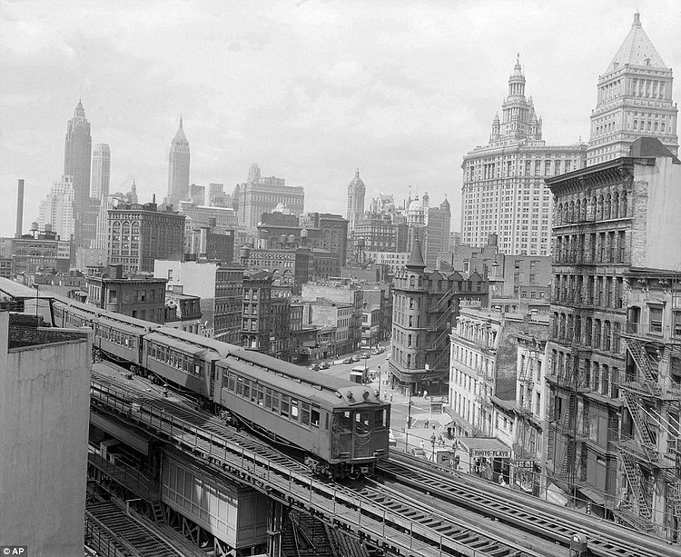 The Third Avenue elevated train rumbles across lower Manhattan, early 1900's.