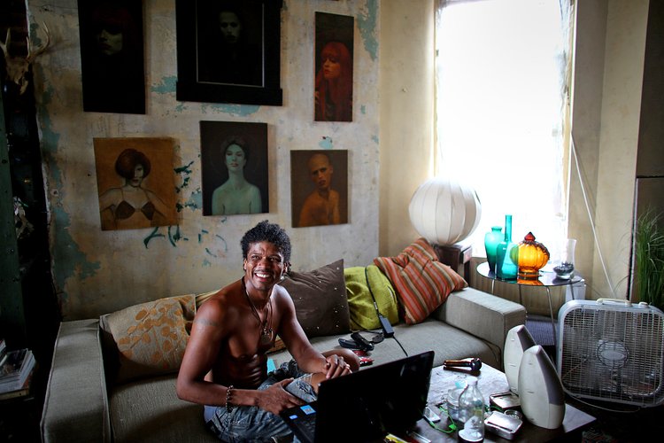 Jean Paul Chatham, originally from Belize, inside the apartment that he shares with Steven Ashmore, an original homesteader.