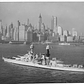The battleship Colorado (BB 45) steams off New York City with the city's historic skyline serving as a backdrop.