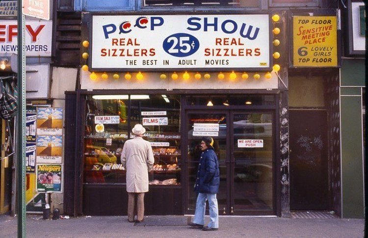 A man looks at the offerings of a peep show store adjacent to a "sensitive meeting place" with "lovely girls." Brothels, typically operated by organized crime, ran in the open without any legal repercussions.