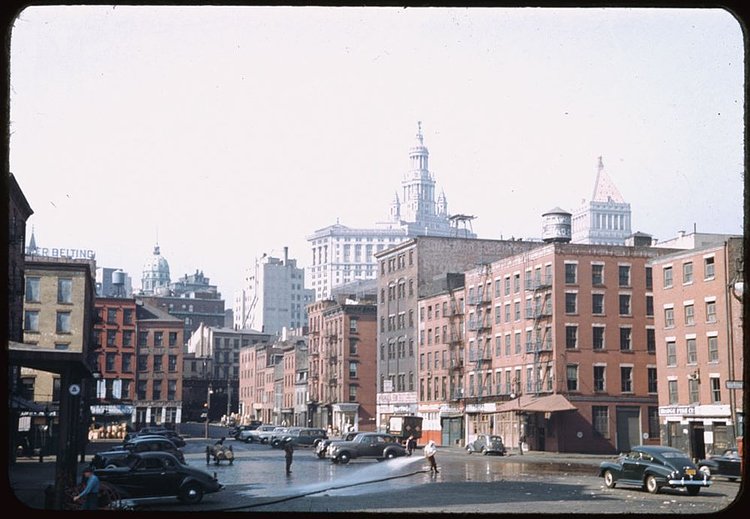 This is a glimpse down Fulton Street, which goes through Manhattan's Financial District, from South Street in 1941.