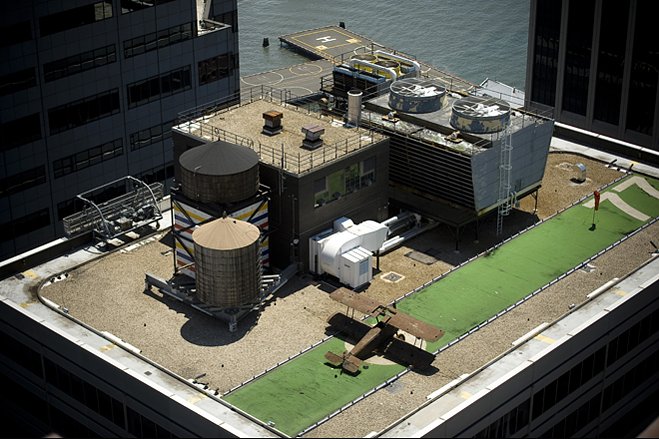 The warplane is parked on a landing strip lined with runway lights.