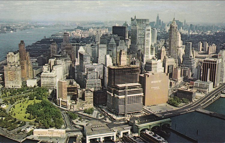 Looking northwest, change has begun as several boxy buildings are under construction near South Street and the FDR Drive as seen directly behind the Staten Island Ferry terminal (1965).