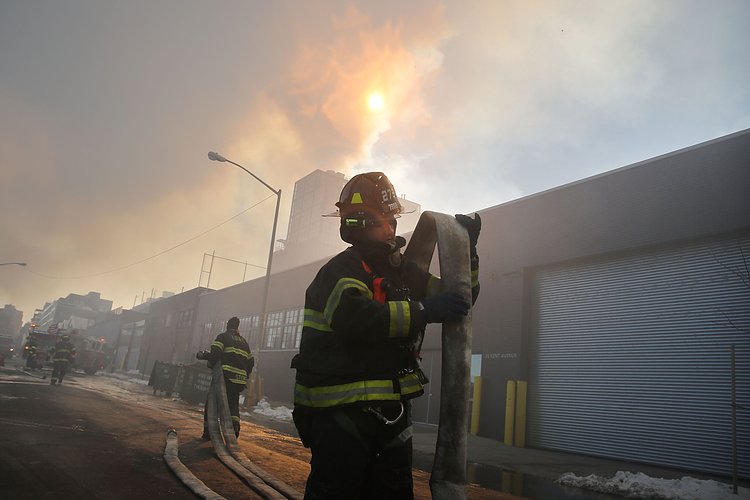 Firefighters continued pouring water on the remains of a 7-alarm fire in a warehouse on the Williamsburg waterfront