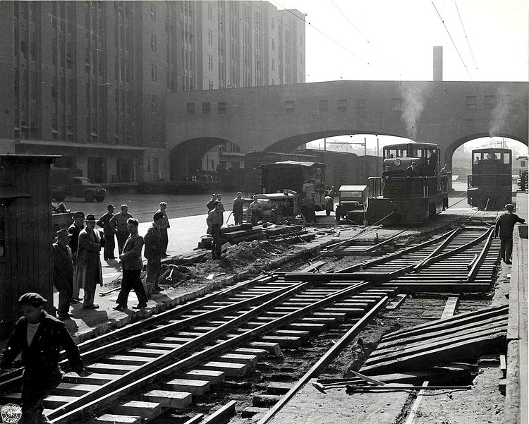 Here's a look at the same area during its military days. As you can see, the parking lots were full of train tracks, so trains could load cargo directly into the buildings or on ships. The skybridges (seen here and in the previous picture) were used to allow people and supplies to move across the complex without disturbing the trains below.
