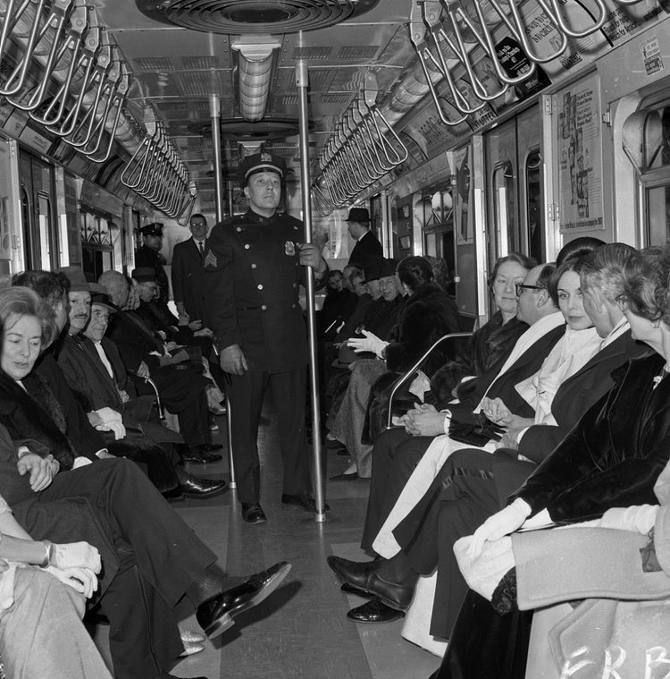1960's: It's a scene straphangers today might not recognize. While passengers sit aboard a subway train, Transit Authority Sgt. Len Cancelleri patrols the crowded car to ensure that no one aboard gets mugged.