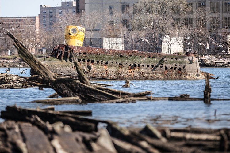 A homemade submarine lies half-submerged in the mud of Coney Island Creek in Brooklyn. The vessel became lodged in the muck shortly after embarking on a failed treasure hunting expedition in the 1970s.