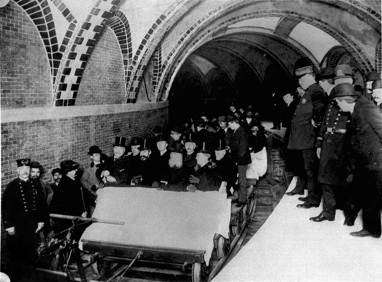 This group of financiers and city officials get a tour of New York City's first subway in January 1904 while the city's policemen stood by on the platform at City Hall Station. Seated toward the front of the ceremonial flat car are Alexander Orr, August Belmont, John B. McDonald, and Mayor George B. McClellen.