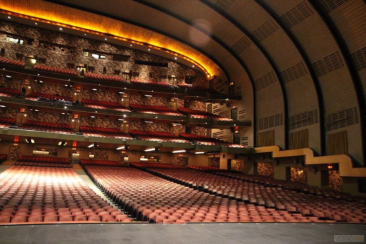 Center Stage, Looking Right | Built in 1932, Radio City Music Hall is a prime example of art deco architectural style that has withstood the test of time. With tons of gold, reflective surfaces and geometric design, walking through the venue is a bit like stepping back in time. Most of the fixtures, furniture and ornamentation are original, and any replacements are exact replicas of how the theater looked 80 years ago.

Read more here: <a href="https://viewing.nyc/i-braved-a-walkthrough-of-radio-city-music-hall-meant-for-tourists/" rel="nofollow">viewing.nyc/i-braved-a-walkthrough-of-radio-city-music-ha...</a>
