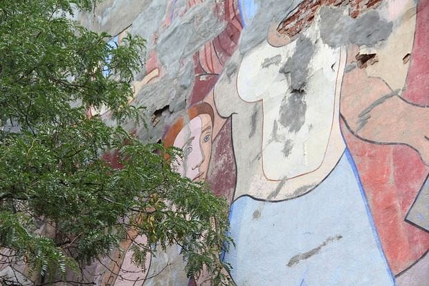 Nearby tree gives a sense of the mural's scale