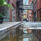 Strolling under the historic Staple Street skybridge after the rain. This skybridge was constructed in 1907 and was used to transport patients from the horse-drawn ambulances to the hospital facilities across the street. TriBeCa, Manhattan, New York City
