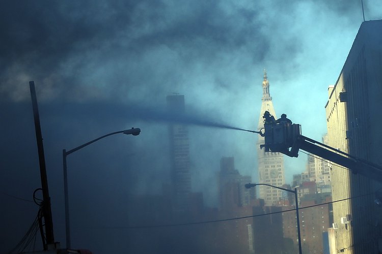 Firefighters continued pouring water on the remains of a 7-alarm fire in a warehouse on the Williamsburg waterfront