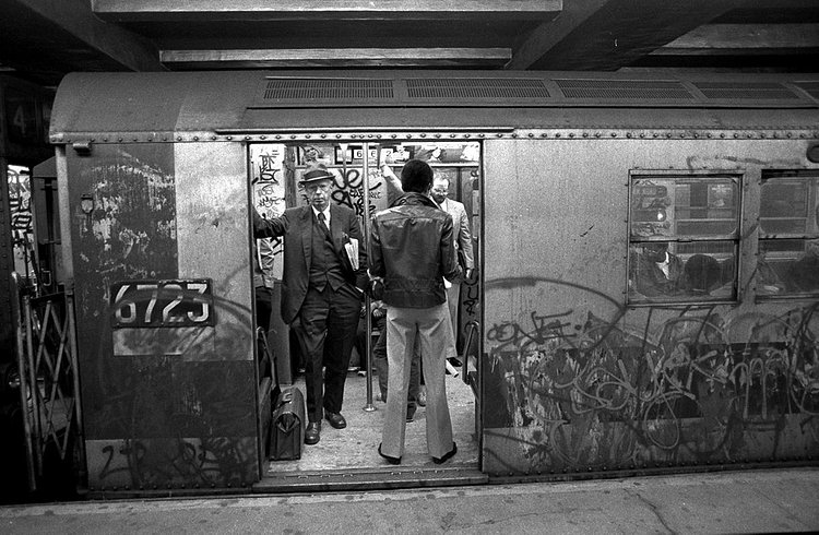 1980's: Subway riders head to work on a dirty, graffiti-covered train along the Lexington Avenue line in 1981.
