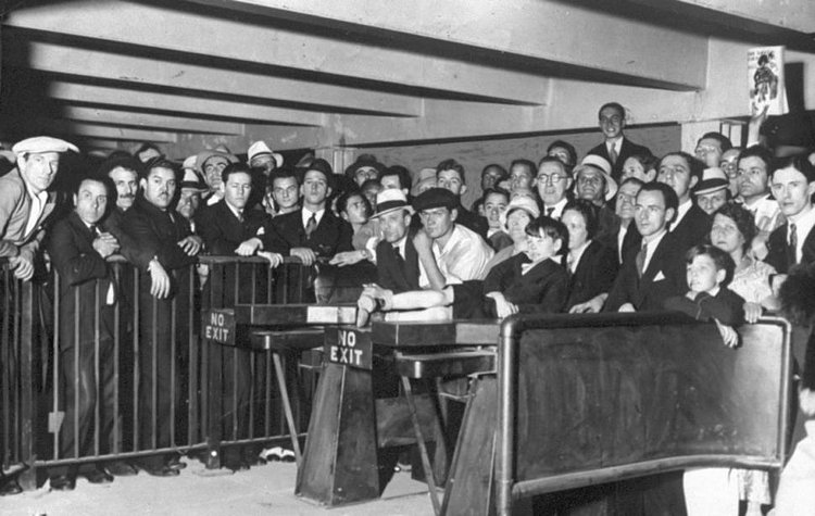 Eight Avenue subway station opens. Young boy, stretched out on the top of this turnstile at 42nd Street, has a real good reason for wanting to be first. His name is William Reilly and he was born on March 14, 1925, the day ground was broken for the Eighth Avenue Subway.