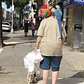 A man walking a dog and two parrots on 3rd Avenue, Bay Ridge, Brooklyn.