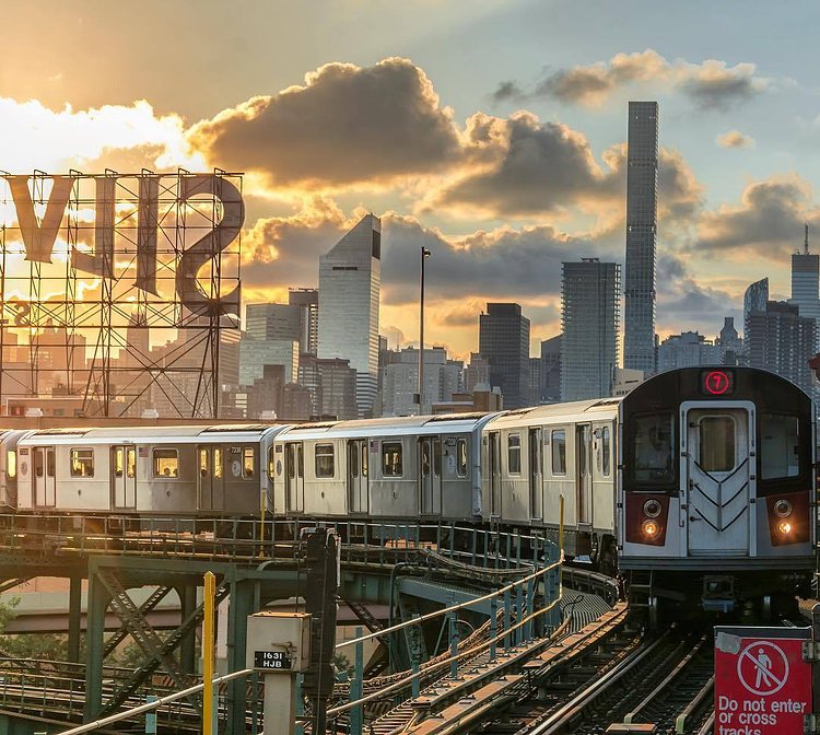 7 subway train on the elevated platform in Queens with the Manhattan skyline in the background. Queensboro Plaza Station, Queens, New York City