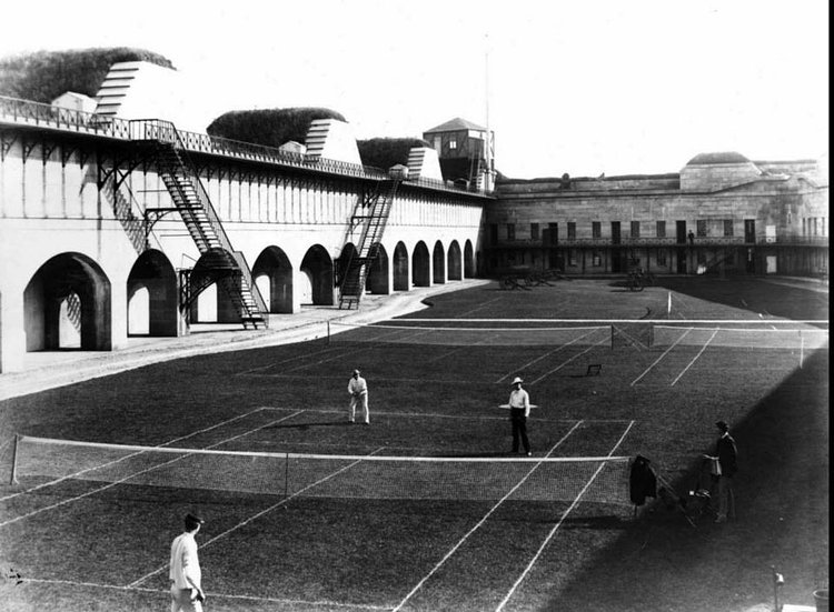 People playing a tennis match at Fort Wadsworth.