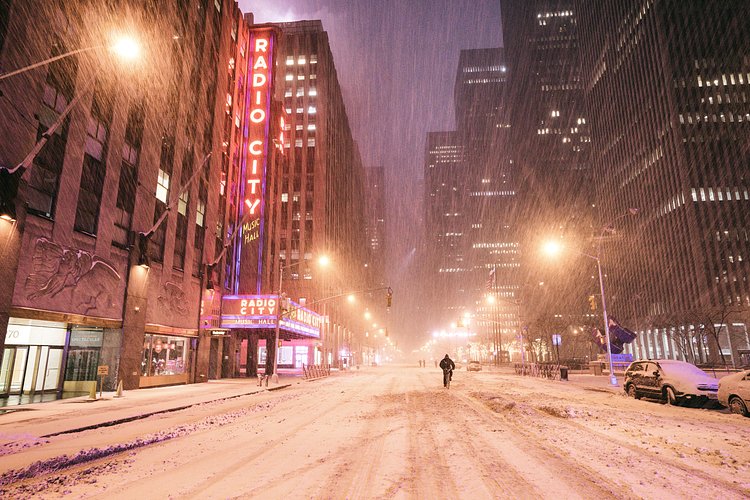 New York City - Snow - Winter Storm Juno - Radio City Music Hall | Juno: The first snowstorm of 2015 in New York City.

---

(Note: My <a href="http://www.amazon.com/gp/product/1440339589/ref=as_li_tl?ie=UTF8&amp;camp=1789&amp;creative=9325&amp;creativeASIN=1440339589&amp;linkCode=as2&amp;tag=nyththle0e-20&amp;linkId=ER6GYT5FRYNMEPLF" rel="nofollow">New York photography book</a> released worldwide in stores/online recently and has photos similar to this  [full info below])

---

I have been photographing New York City during snowstorms at night for the past 5 years. When it comes to experiencing <a href="http://nythroughthelens.com/tagged/snow" rel="nofollow">New York City in the snow</a>, I relish the challenge. The more gusty, snowy, and brutal the storm, the more of a chance that I will be out in it traipsing around New York City with my cameras in tow.

When I heard that the MTA was suspending all transit service (and most vehicles) at 11 pm, I made the decision to take the train up to the Upper East Side prior to 11 pm to deposit myself up there with the intention of walking from the Upper East Side to Times Square and then walking the several miles back to the Lower East Side (whew!!).

The streets were eerily empty.

Emptier than they are usually at night during snowfall. Since there was a ban on all vehicles aside from snow plows and emergency services, there were practically no cars at all on the streets. Even taxis were banned from the streets!

I walked in the middle of avenues and streets that are usually teeming with cars.

There was an eerie sense of calm.

It was magical.


---

This is part of a post that I posted to my NYC photography blog. If you are curious enough to look at the photos there, here is the link to the post:

<a href="http://nythroughthelens.com/post/109291619025/new-york-city-snow-winter-storm-juno-i" rel="nofollow">New York City - Winter Storm Juno</a>


----

* As mentioned above - My New York City coffee table book that released in stores/online worldwide recently.

 Tons of information about my <a href="http://www.amazon.com/gp/product/1440339589/ref=as_li_tl?ie=UTF8&amp;camp=1789&amp;creative=9325&amp;creativeASIN=1440339589&amp;linkCode=as2&amp;tag=nyththle0e-20&amp;linkId=ER6GYT5FRYNMEPLF" rel="nofollow">New York photography book</a> with sample pages (including where to order and what stores are carrying it) here:

<a href="http://nythroughthelens.com/post/92873566010/ny-through-the-lens-the-book-i-am-super" rel="nofollow">NY Through The Lens: A New York Coffee Table Book</a>
---


View my New York City photography at my website <a href="http://nythroughthelens.com/" rel="nofollow">NY Through The Lens</a>.

View my Travel photography at my travel blog: <a href="http://travelinglens.me/" rel="nofollow">Traveling Lens</a>.

Interested in my work and have questions about PR and media? Check out my:

<a href="http://nythroughthelens.com/about" rel="nofollow">About Page</a> | <a href="http://nythroughthelens.com/PR" rel="nofollow">PR Page</a> | <a href="http://nythroughthelens.com/media" rel="nofollow">Media Page</a>