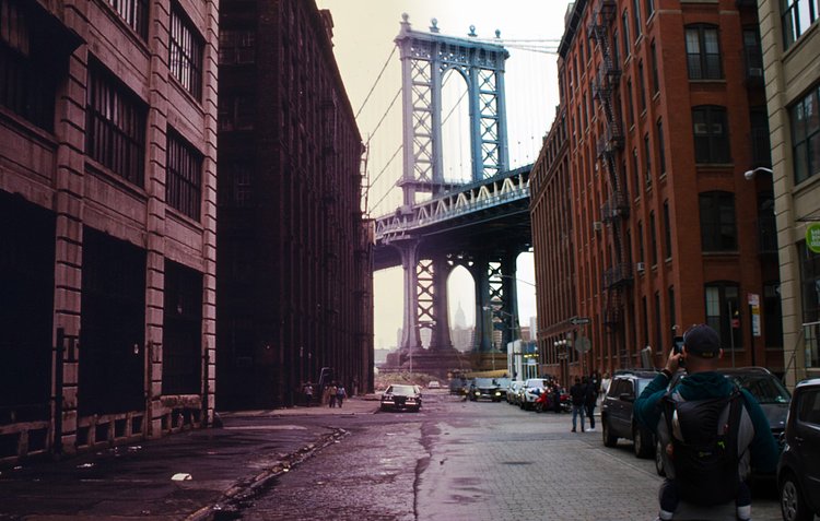 A view of the Manhattan Bridge from Brooklyn, with the view from 1970 on the left and today's view on the right.
