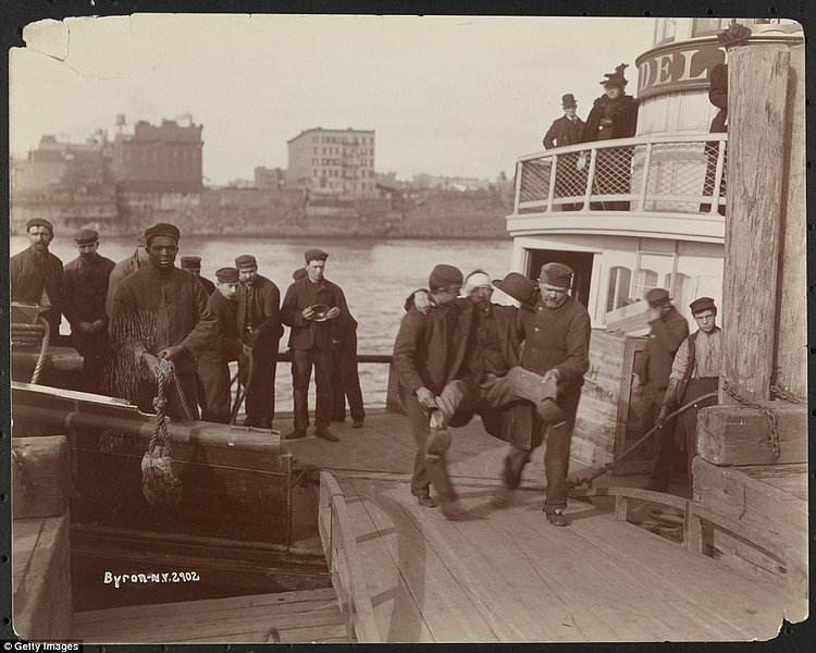 Two men carrying a patient from the ferry to the pier on Welfare Island, New York, New York, mid 1890s 