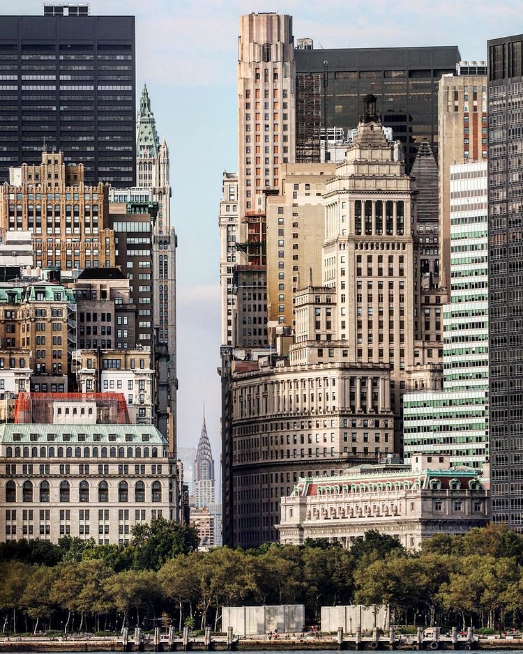 Looking up Broadway with a view of the Chrysler Building sticking in between the large canyon of stone walls