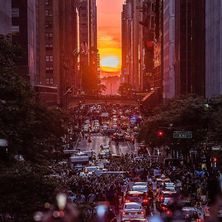 The sun sets along 42nd street, aligning with the #NewYork street grid to create the #Manhattanhenge phenomenon on Thursday evening.