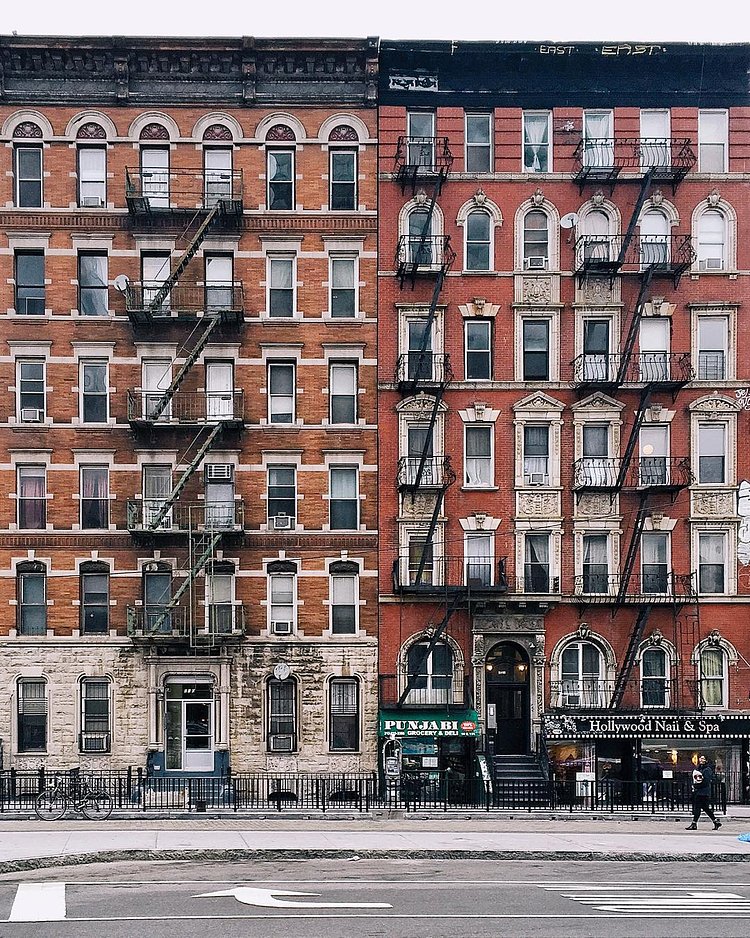 E Houston st. Fire escapes and old fashioned steam heaters.