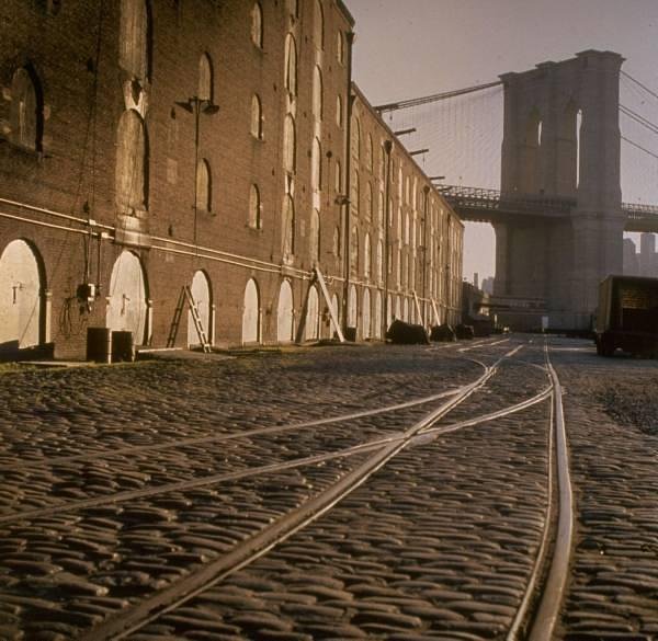 Abandoned railroad tracks dart along the cobblestones of the Brooklyn waterfront, by Walker Evans 1960