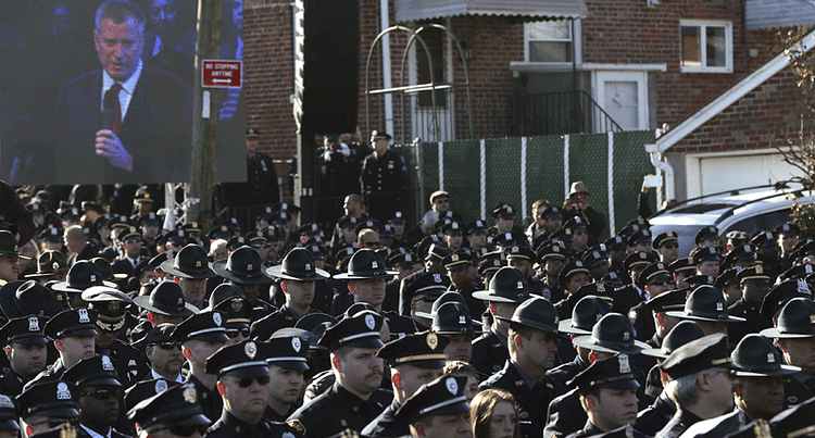 Law enforcement officers turn their backs on a video monitor as New York City Mayor Bill de Blasio speaks during the funeral of slain New York Police Department (NYPD) officer Rafael Ramos near Christ Tabernacle Church in the Queens borough of New York December 27, 2014.