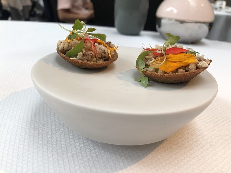 Amuse Bouche. Buckwheat tartlet with green tomatoes and horseradish.