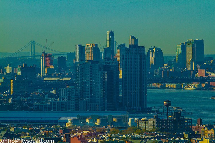 Williamsburg, and Lower Manhattan. The watertower at Greenpoint Terminal is in the foreground.
