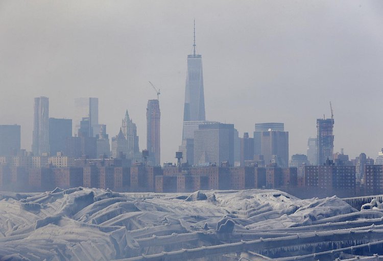 Firefighters continued pouring water on the remains of a 7-alarm fire in a warehouse on the Williamsburg waterfront