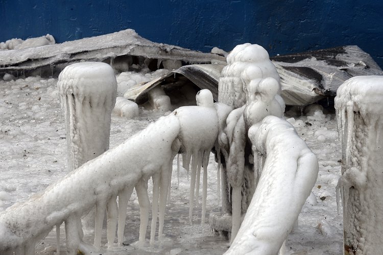 Firefighters continued pouring water on the remains of a 7-alarm fire in a warehouse on the Williamsburg waterfront