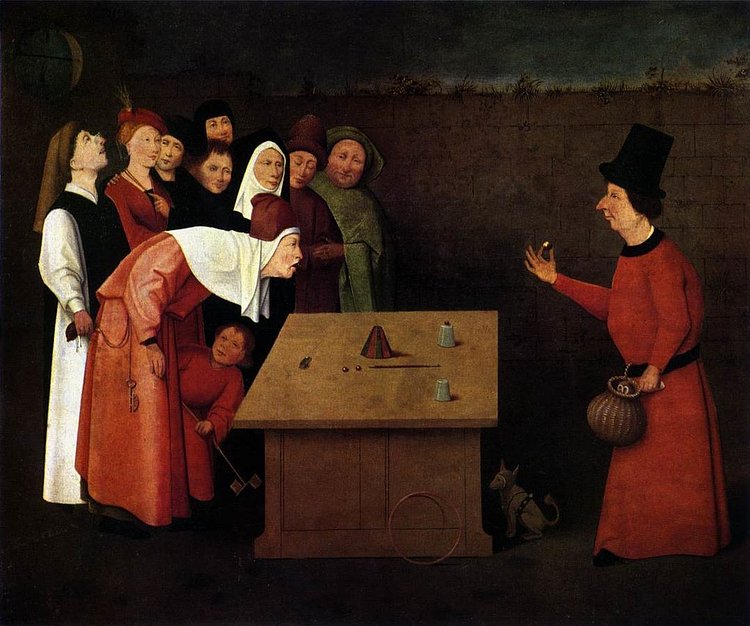"The Conjurer," painted by Hieronymus Bosch. The painting accurately displays a performer doing the cups and balls routine, which has been practiced since Egyptian times.