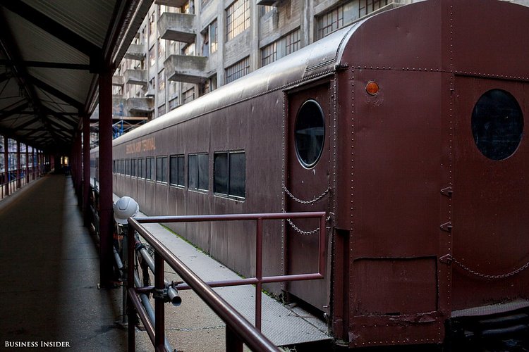 The EDC placed this train here to commemorate the building's history as a train depot. It is a Long Island Rail Road car from the 1950s.